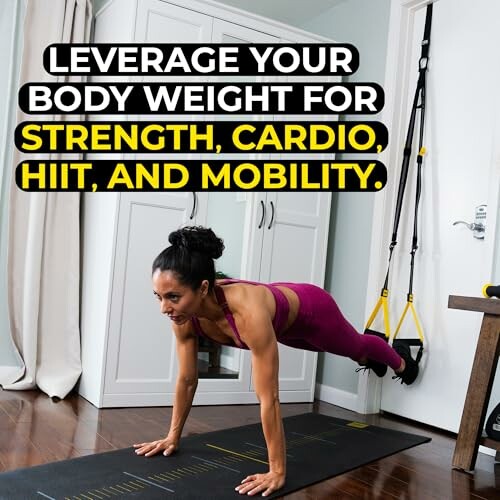 Woman performing a plank exercise with TRX straps in a home setting.