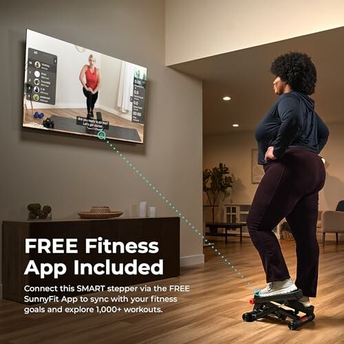 Person using a stepper watching a fitness app on TV.