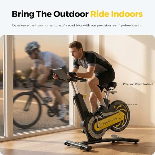 Man riding an indoor cycling bike with outdoor cyclist in the background.