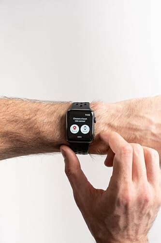 Person interacting with smartwatch on wrist.