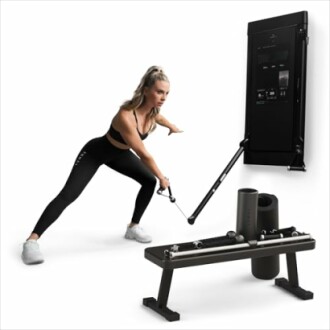 Woman exercising with a wall-mounted fitness machine, showcasing Tonal 2's space-saving design.