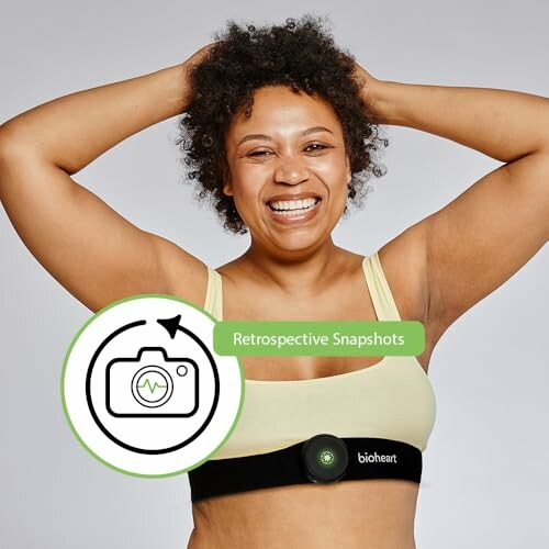 Woman smiling and wearing a fitness monitor on her chest.